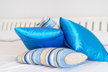 pile of blue satin pillows